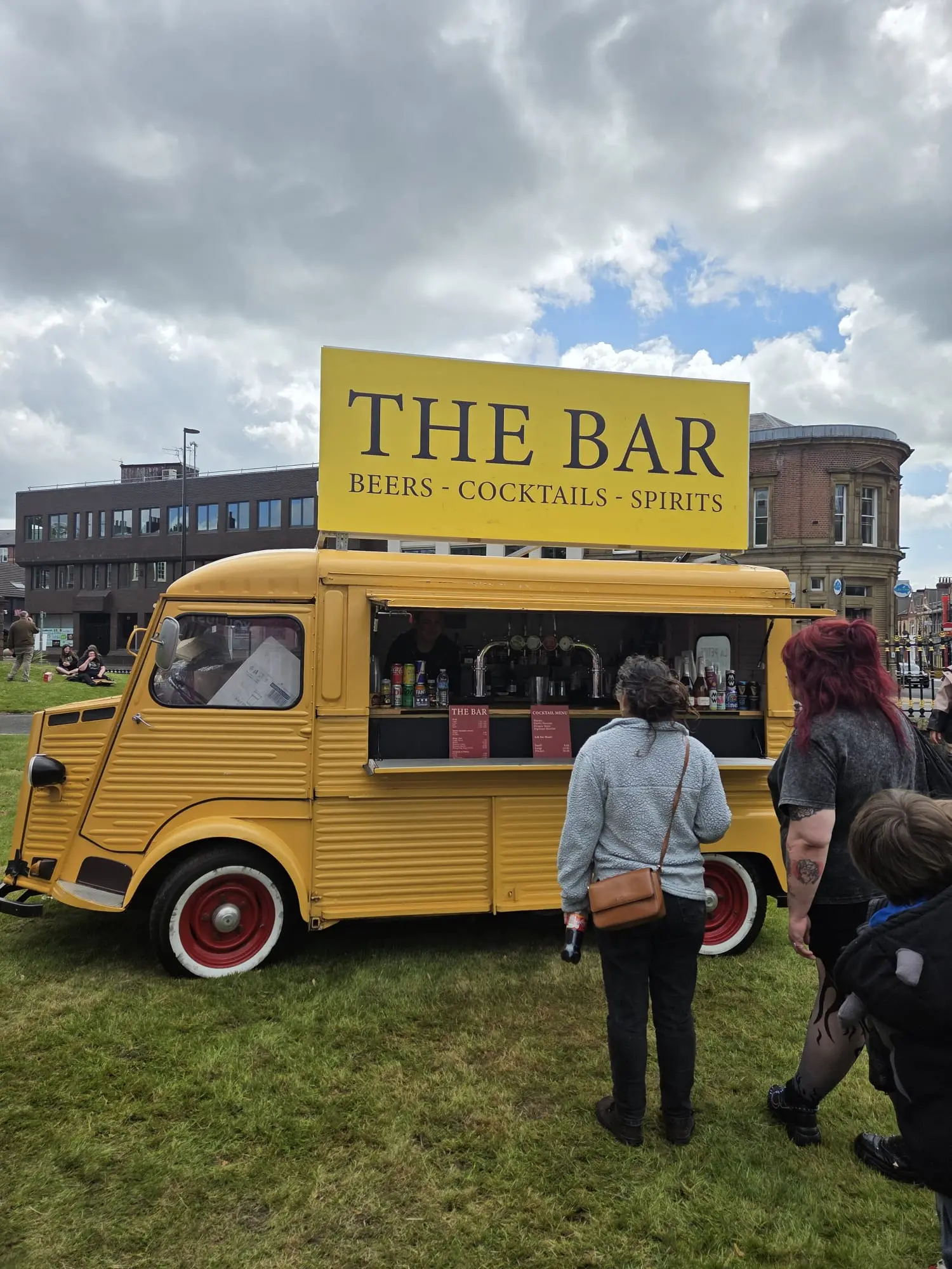 Yellow mobile bar serving guests at a city event
